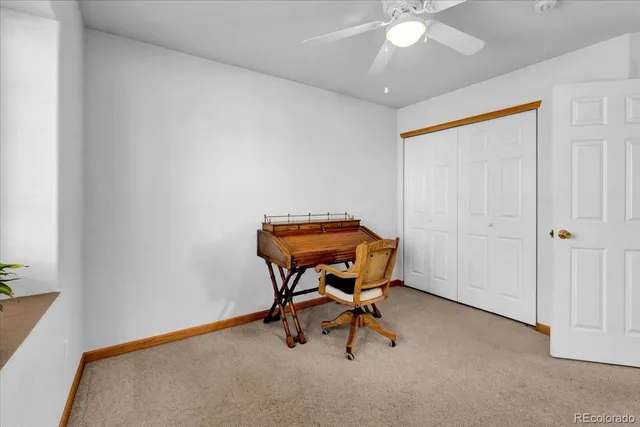a spacious bedroom with a bed and a chandelier