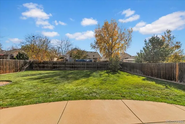 a view of a backyard with sitting area
