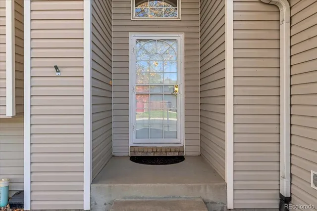 a view of a hallway with wooden floor and a window
