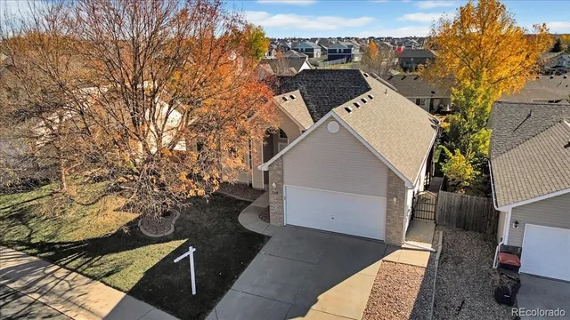 an aerial view of a house with a yard and street