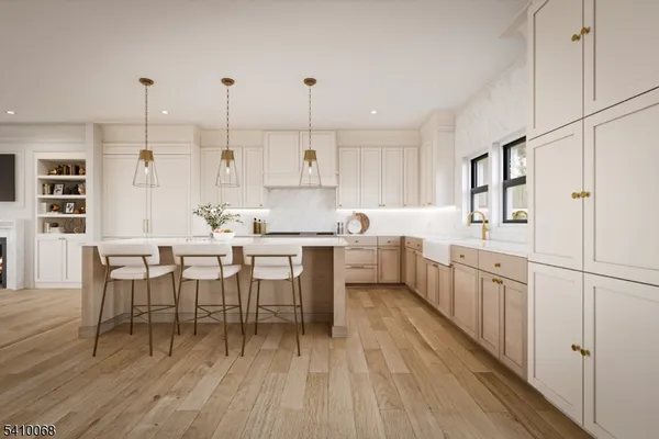 a kitchen with kitchen island granite countertop a sink cabinets and wooden floor