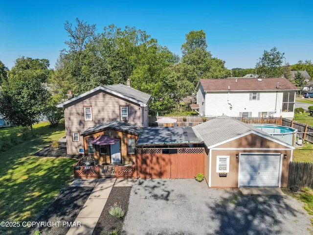 an aerial view of a house with a swimming pool