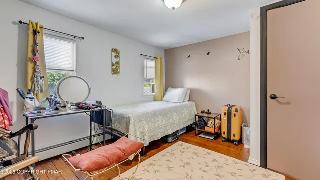 an aerial view of a house with a swimming pool a yard and a large tree
