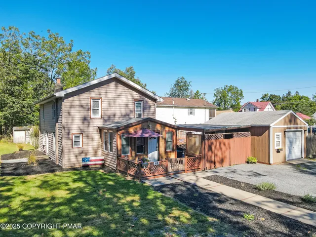 a view of house with outdoor seating area