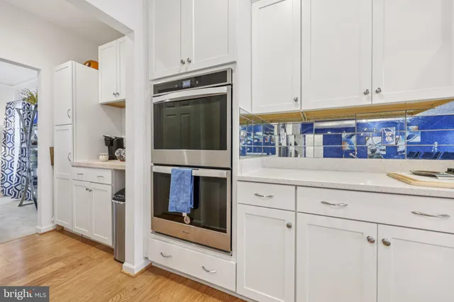 a kitchen with stainless steel appliances white cabinets and a sink