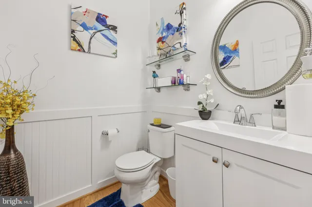 a bathroom with a sink a mirror and a toilet