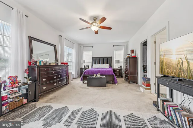 a bedroom with furniture and a flat screen tv