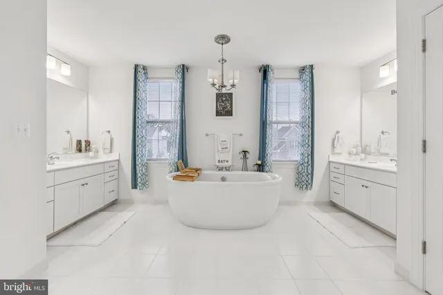 a large bathroom with a double vanity sink a mirror and a bathtub