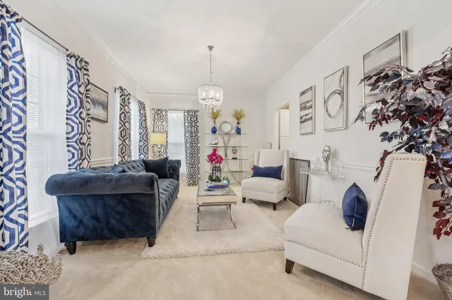 a living room with furniture and a chandelier