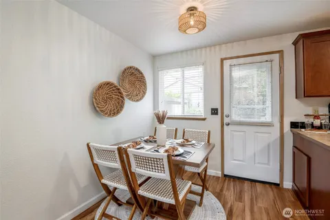 a dining room with furniture a window and wooden floor