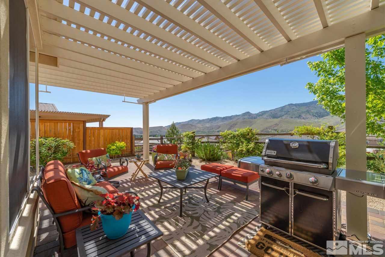 1149 Dutch Hollow Trail Reno, NV 89523 - Photo 14 of 38 a view of a patio with a dining table and chairs with wooden floor
