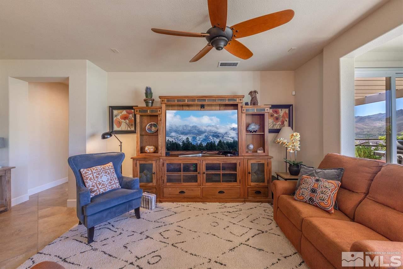 1149 Dutch Hollow Trail Reno, NV 89523 - Photo 6 of 38 a living room with furniture a flat screen tv and a window