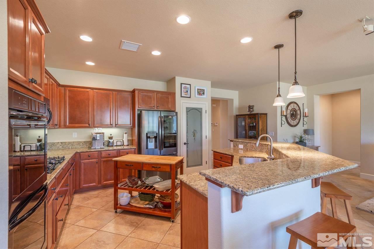 1149 Dutch Hollow Trail Reno, NV 89523 - Photo 9 of 38 a kitchen with center island and chairs