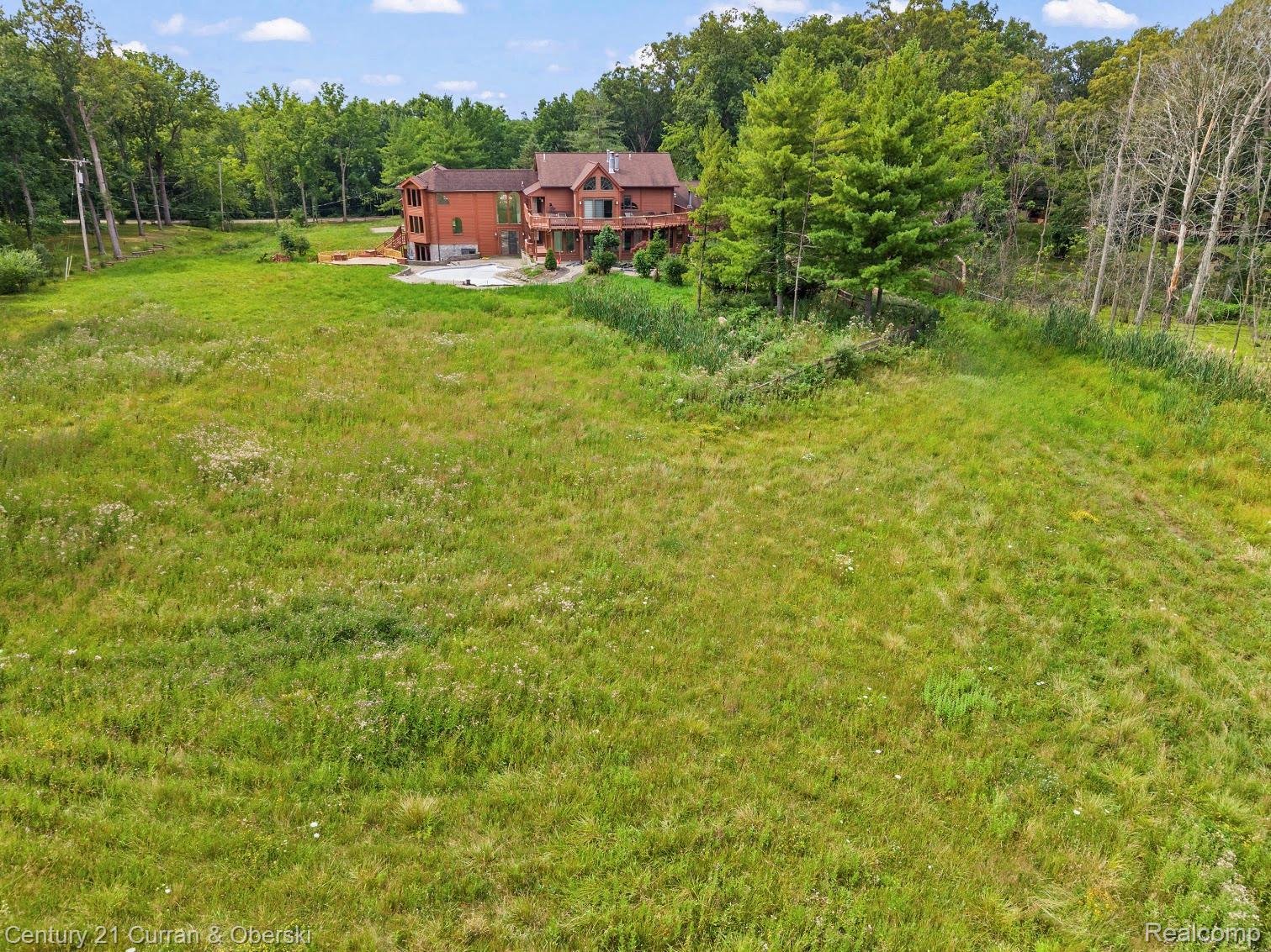 8785 Warren Road Plymouth, MI 48170 - Photo 38 of 46 Expansive green space with distant multi-story residence