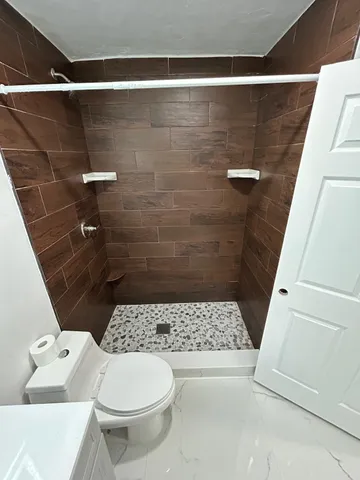 a view of a car parked in front of a house with a big yard