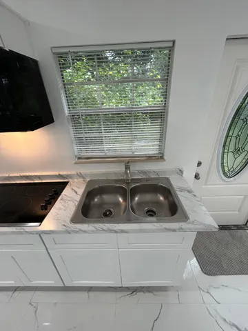 a kitchen with a sink and a stove