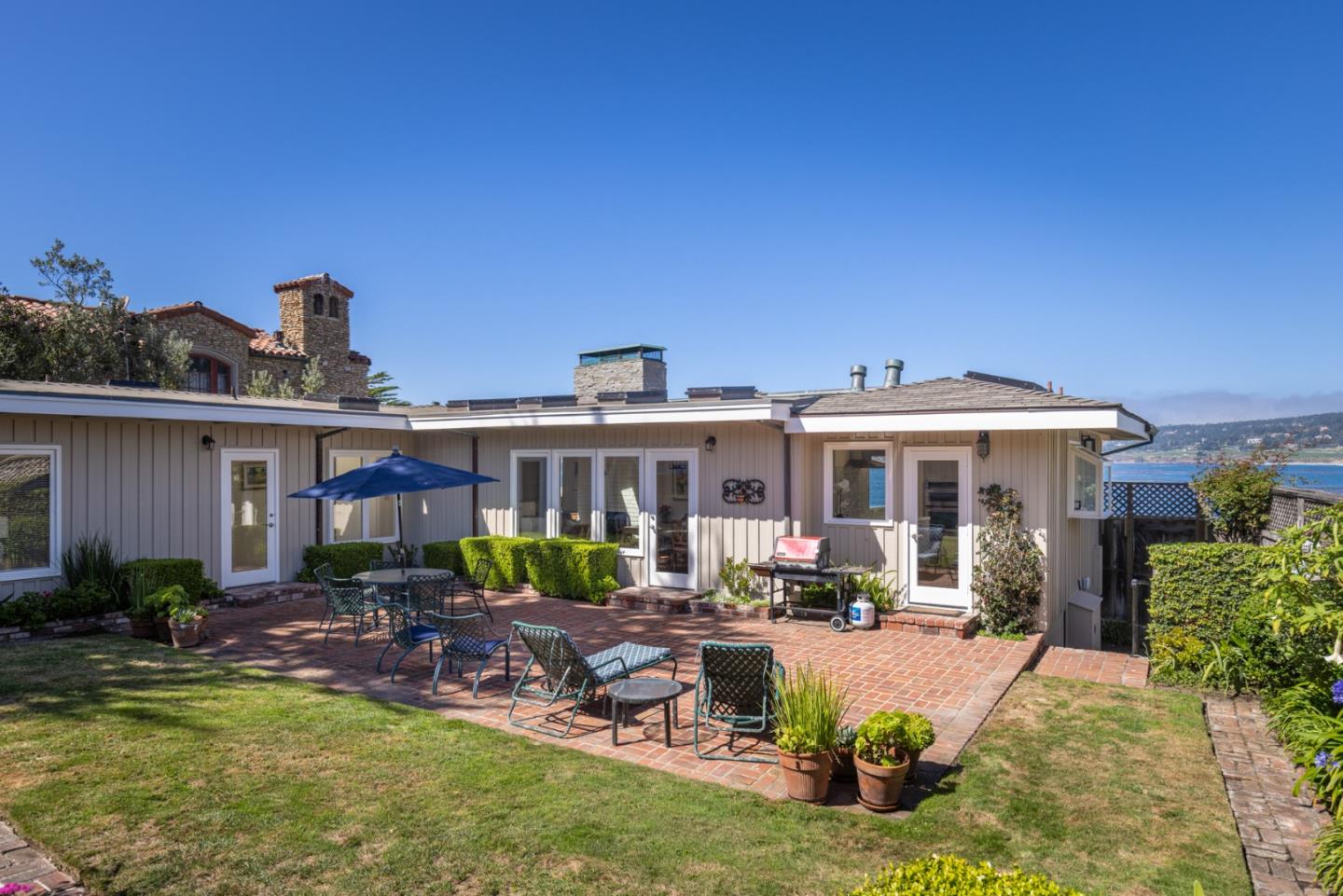 26177 Scenic Road Carmel, CA 93923 - Photo 14 of 30 a front view of a house with swimming pool having outdoor seating