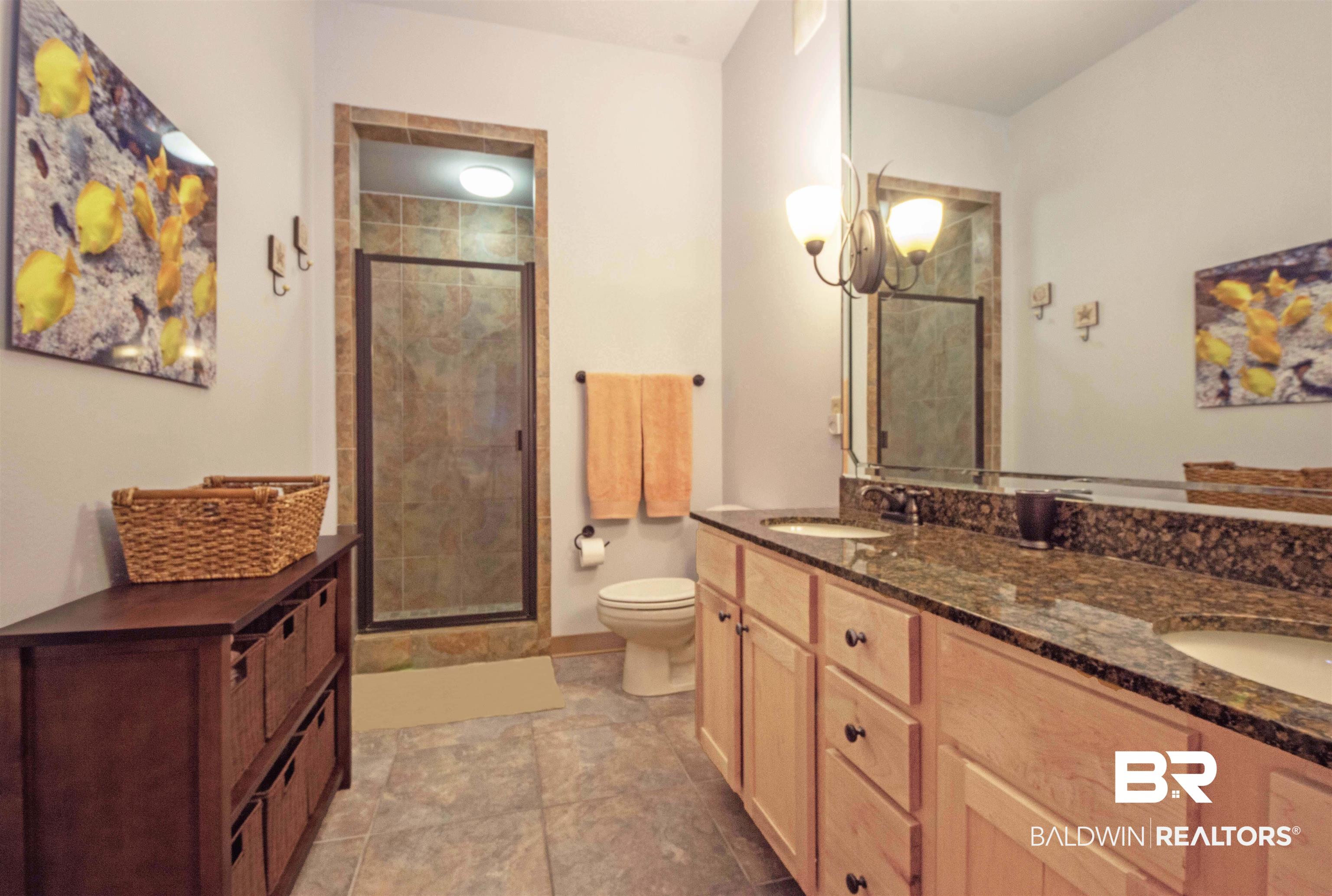 1430 Regency Road, Unit 301C Gulf Shores, AL 36542 - Photo 14 of 22 Master Bathroom with toilet, tile patterned floors, enclosed shower, and dual vanity