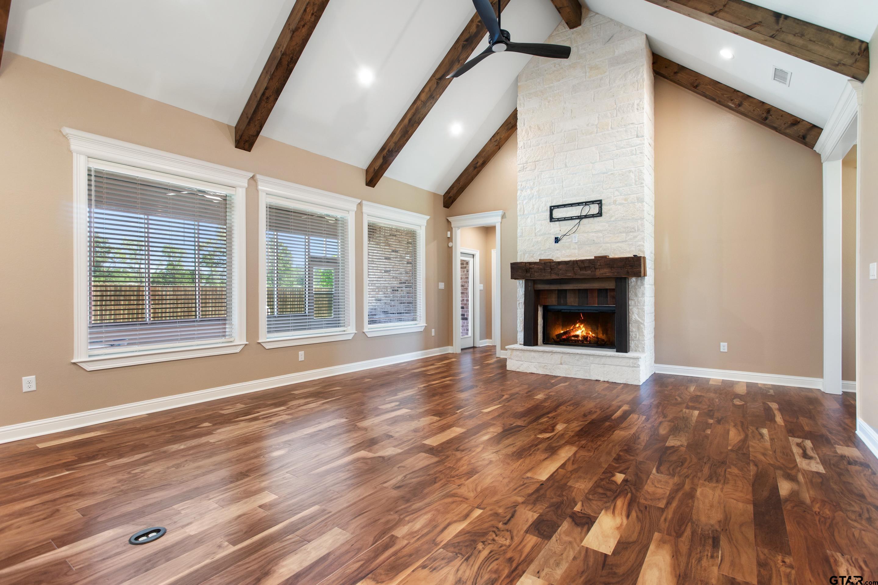 105 Nathan Road Chandler, TX 75758 - Photo 4 of 36 a view of an empty room with wooden floor fireplace and a window