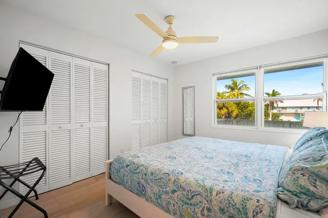 a bedroom with a bed and flat screen tv
