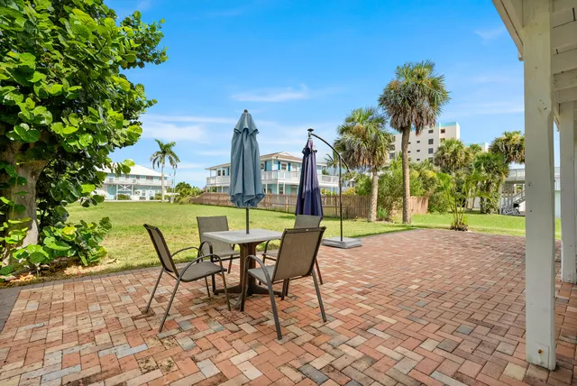 a view of a patio with a table and chairs