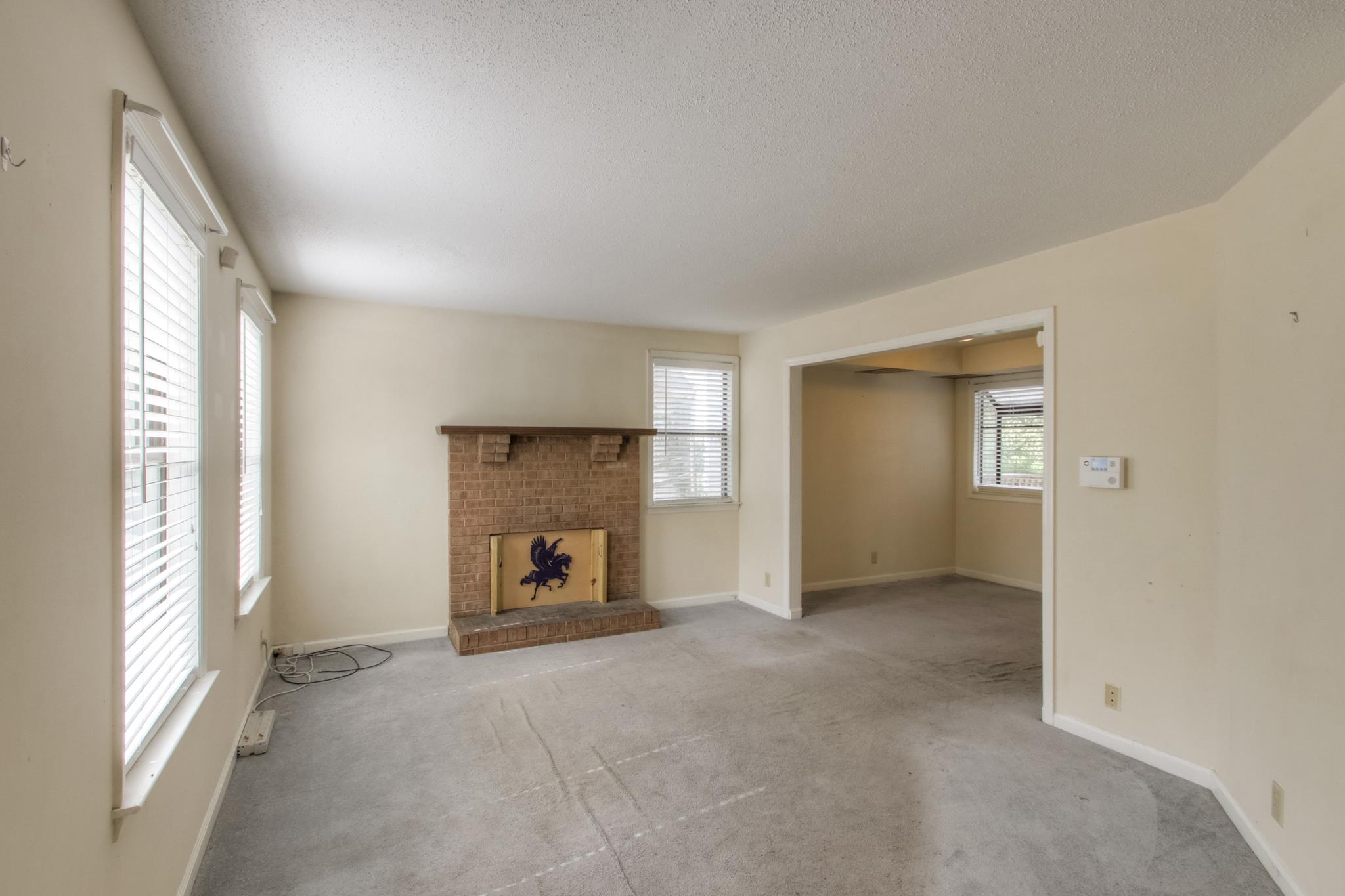 3240 Anderson Road, Unit A Antioch, TN 37013 - Photo 6 of 17 a view of an empty room with a fireplace and a window