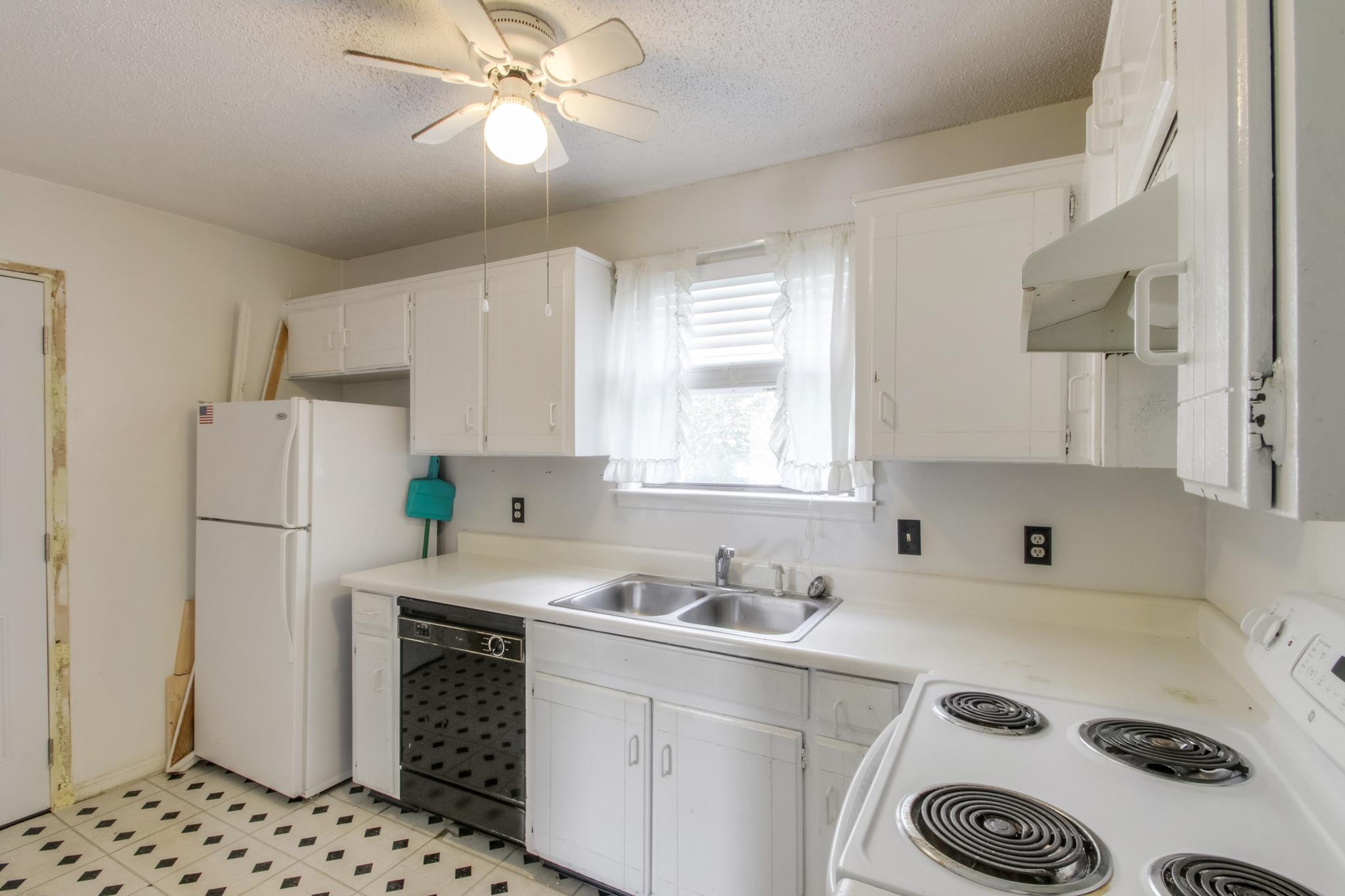 3240 Anderson Road, Unit A Antioch, TN 37013 - Photo 8 of 17 a kitchen with a refrigerator a sink and a window