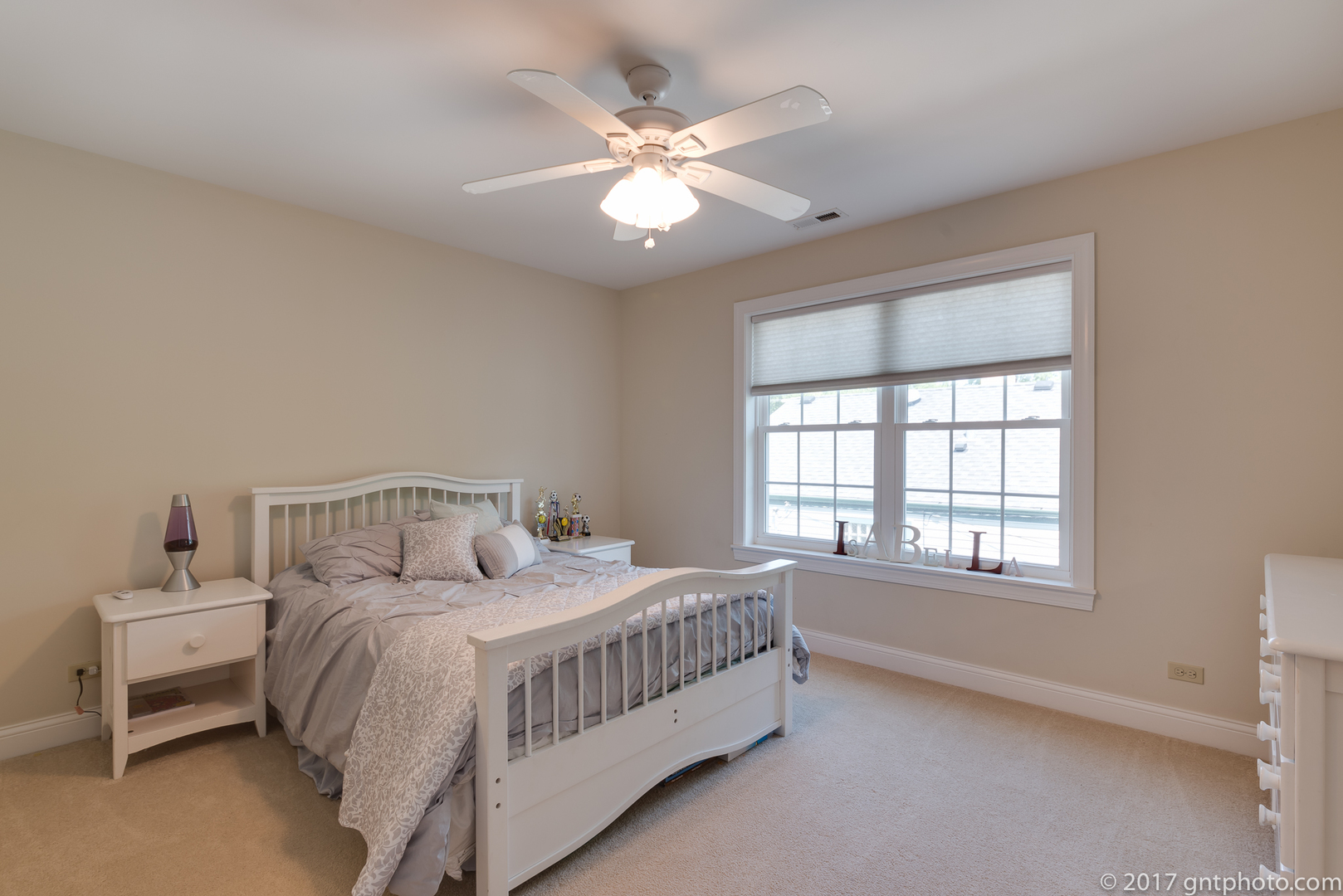 939 Spring Road Elmhurst, IL 60126 - Photo 14 of 28 a bedroom with a bed and a chandelier