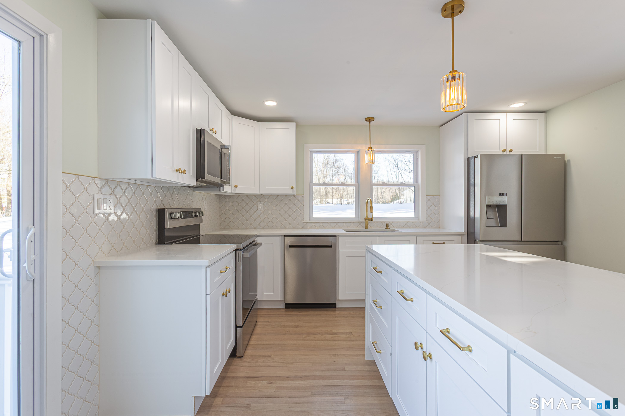 26 Kelly Road Hamden, CT 06518 - Photo 13 of 37 a kitchen with white cabinets appliances and sink