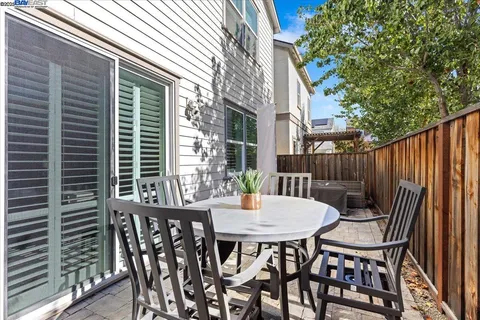 a view of a patio with a table and chairs