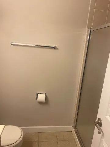 a bathroom with a shower and toilet
