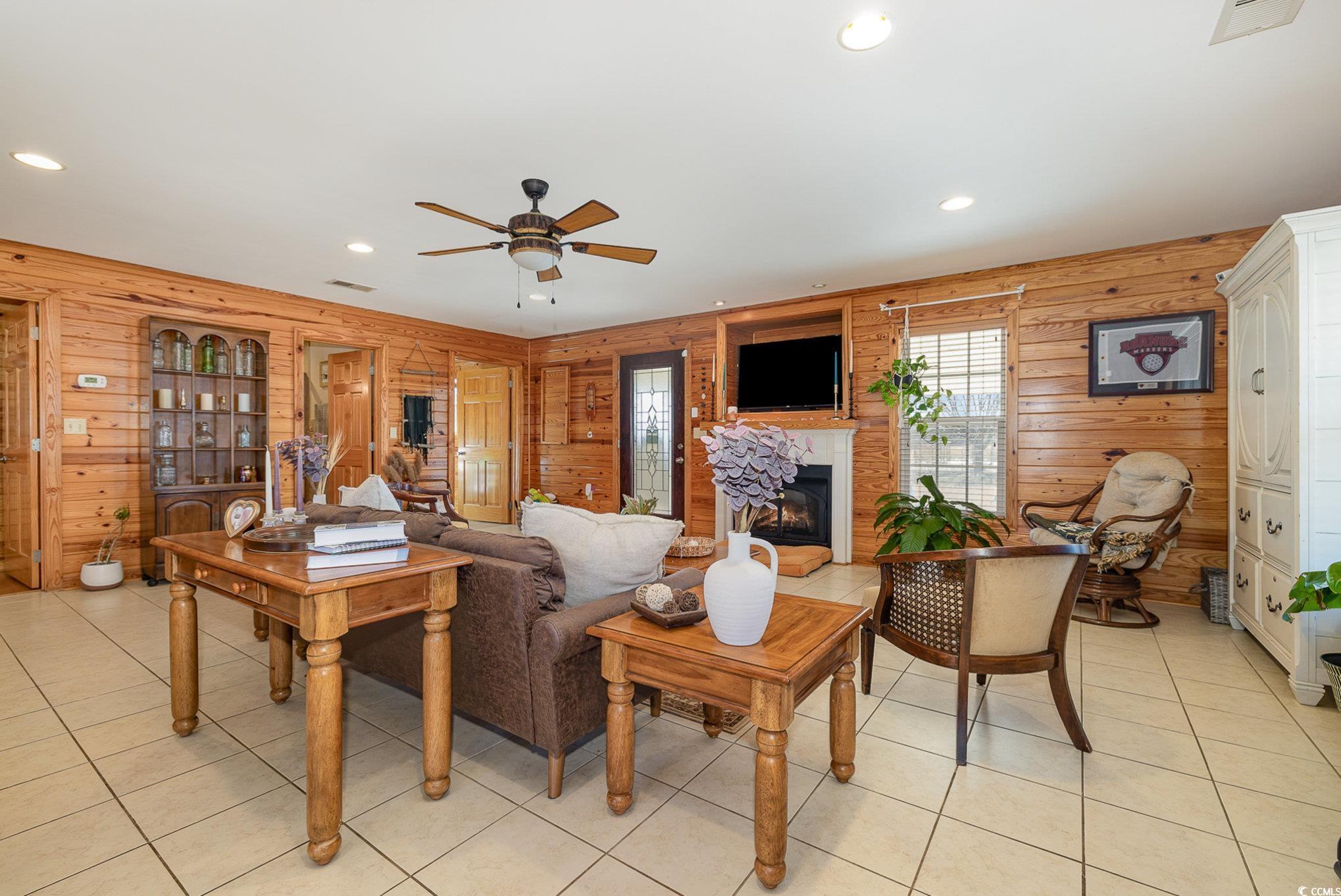 3658 Edwards Road Aynor, SC 29511 - Photo 29 of 39 Tiled living room with ceiling fan and wood walls