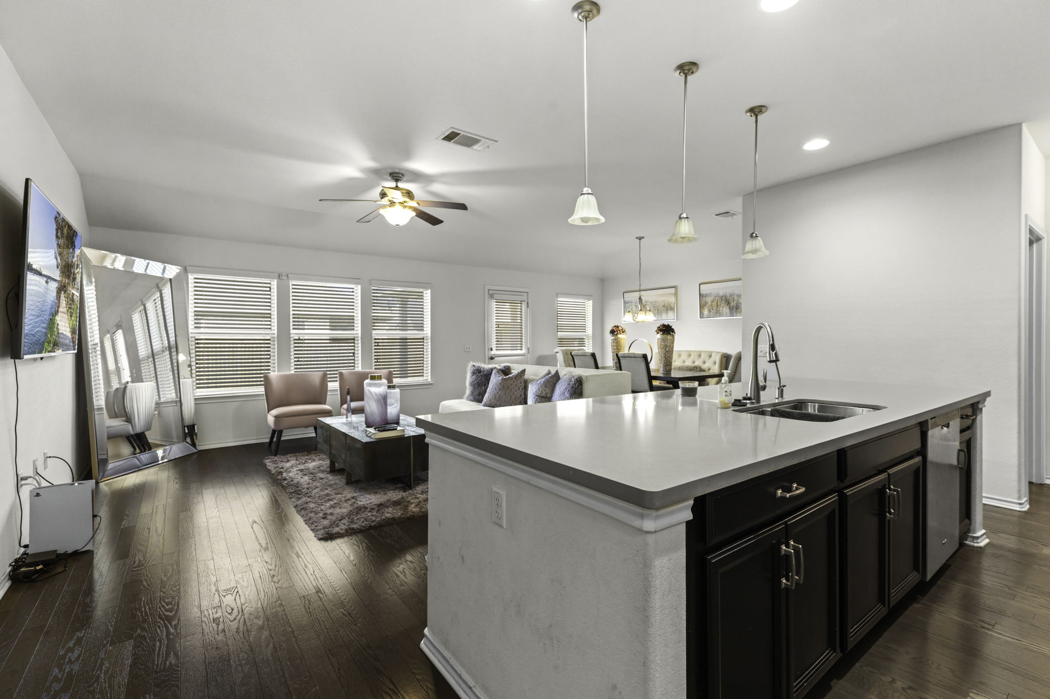 3116 Bragg Place Pflugerville, TX 78660 - Photo 28 of 29 a open kitchen with stainless steel appliances granite countertop a sink dishwasher a stove and a dining table with wooden floor