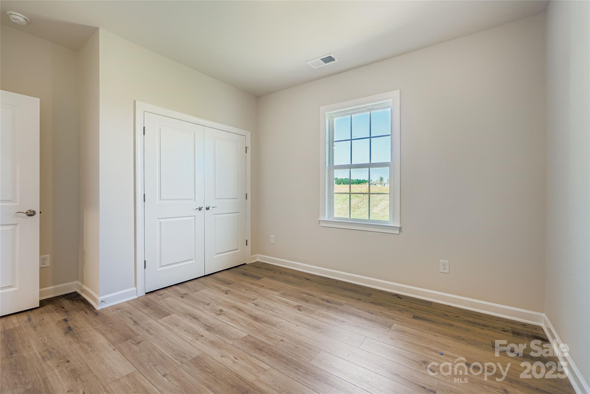 2252 Moon Crst Road Lancaster, SC 29720 - Photo 8 of 16 an empty room with wooden floor and windows