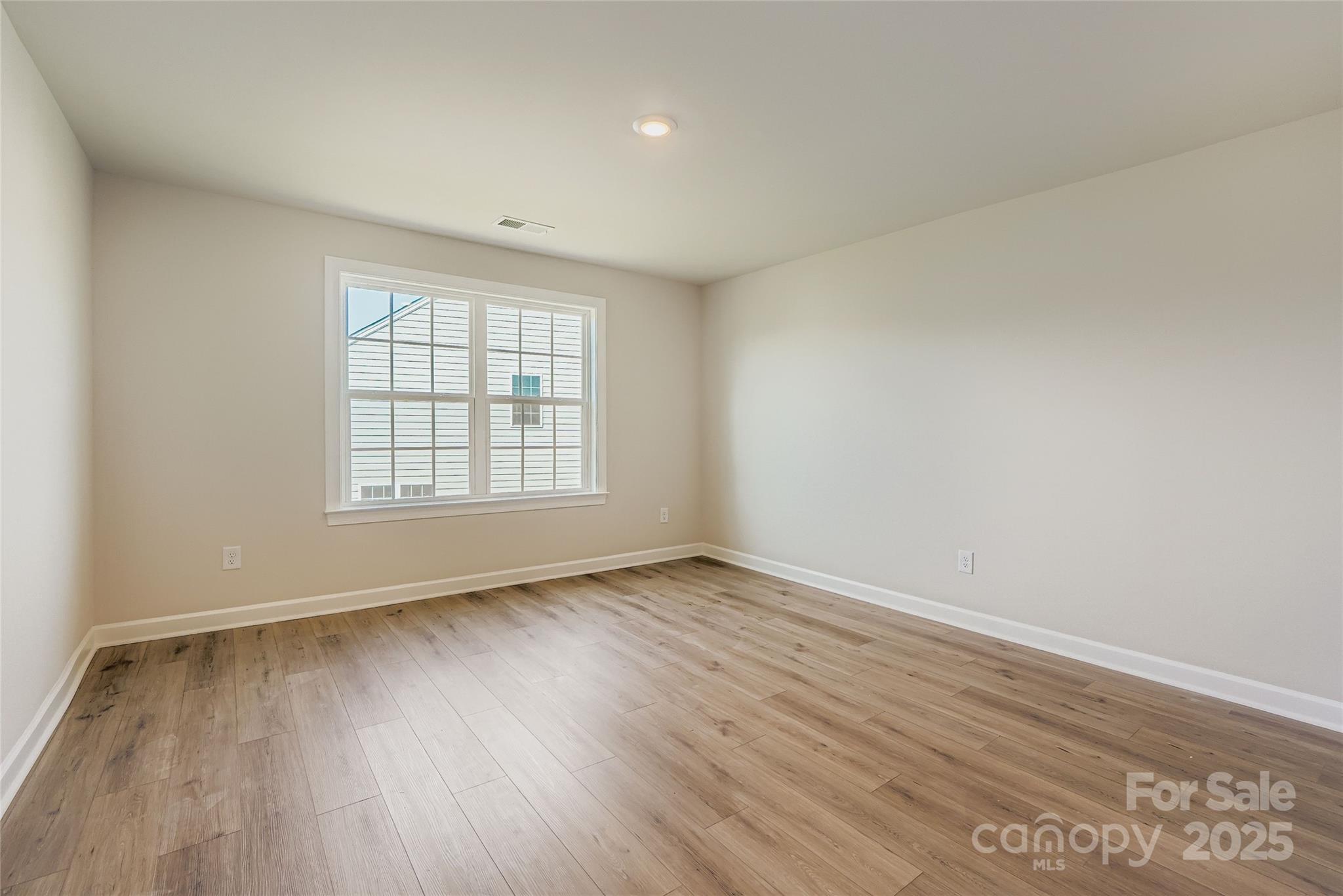 2252 Moon Crst Road Lancaster, SC 29720 - Photo 10 of 16 an empty room with wooden floor and windows
