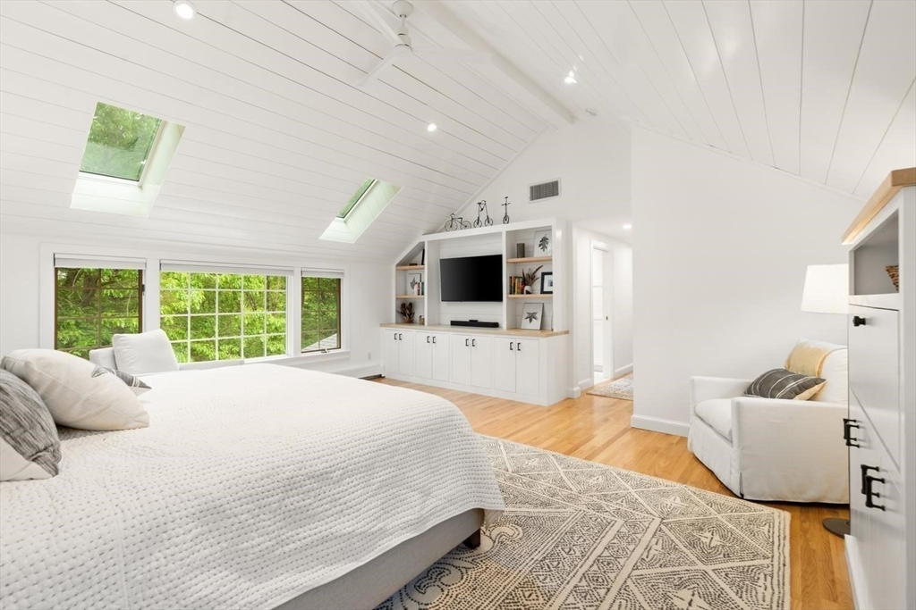 105 Thornberry Road Winchester, MA 01890 - Photo 18 of 35 a spacious bedroom with a bed and a television