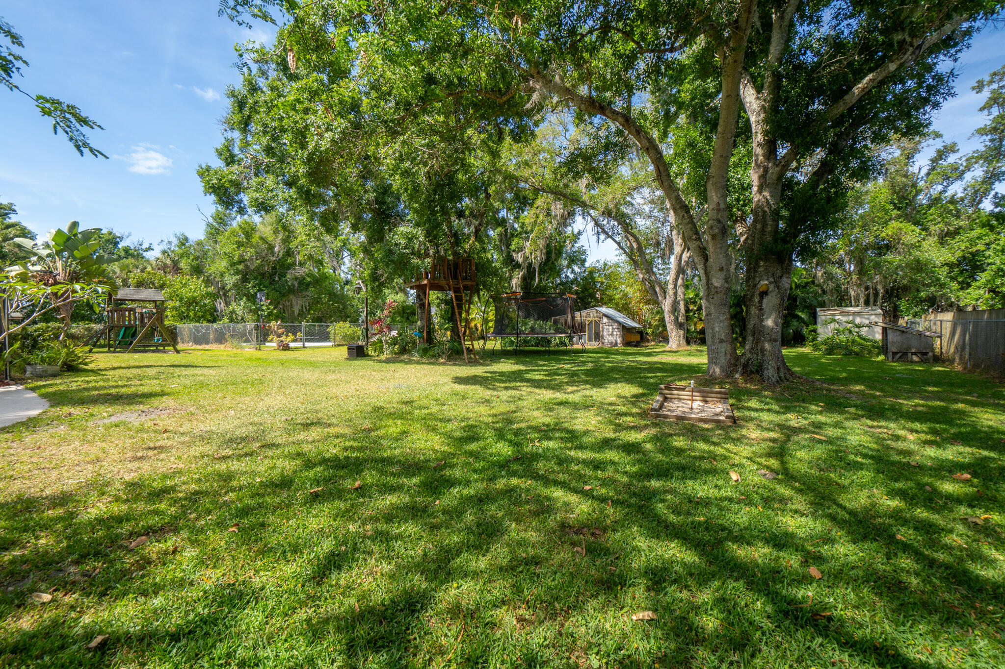 810 Knecht Road Northeast Palm Bay, FL 32905 - Photo 9 of 63 a backyard of a house with lots of green space