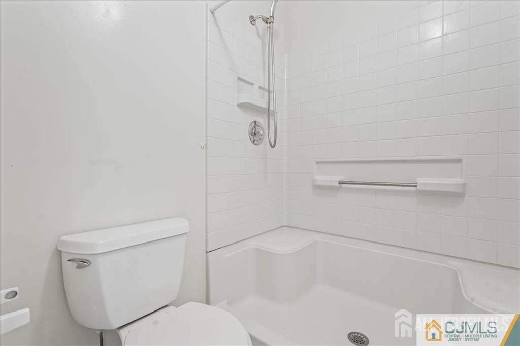 834 Edpas Road New Brunswick, NJ 08901 - Photo 4 of 20 a white toilet sitting next to a bath tub