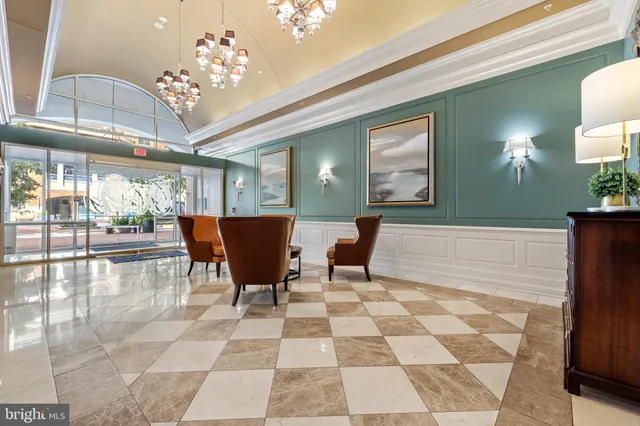 a view of a dining room with furniture and chandelier