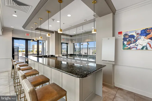 a kitchen with stainless steel appliances granite countertop a sink and a refrigerator