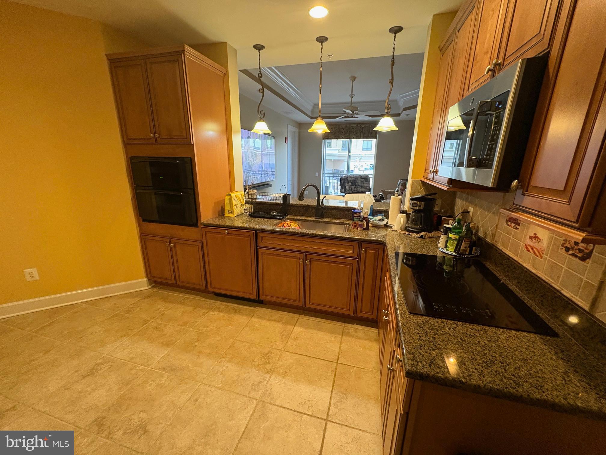 1915 Towne Centre Boulevard, Unit 309 Annapolis, MD 21401 - Photo 5 of 25 a kitchen with stainless steel appliances granite countertop a sink stove and refrigerator