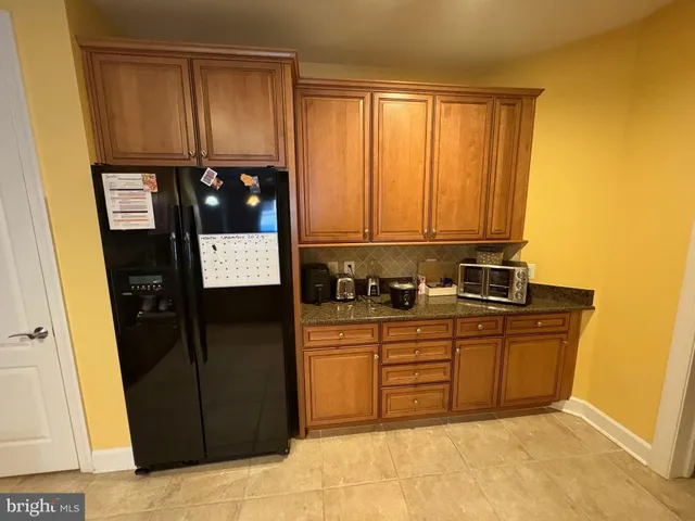 a kitchen with stainless steel appliances granite countertop a refrigerator and a stove