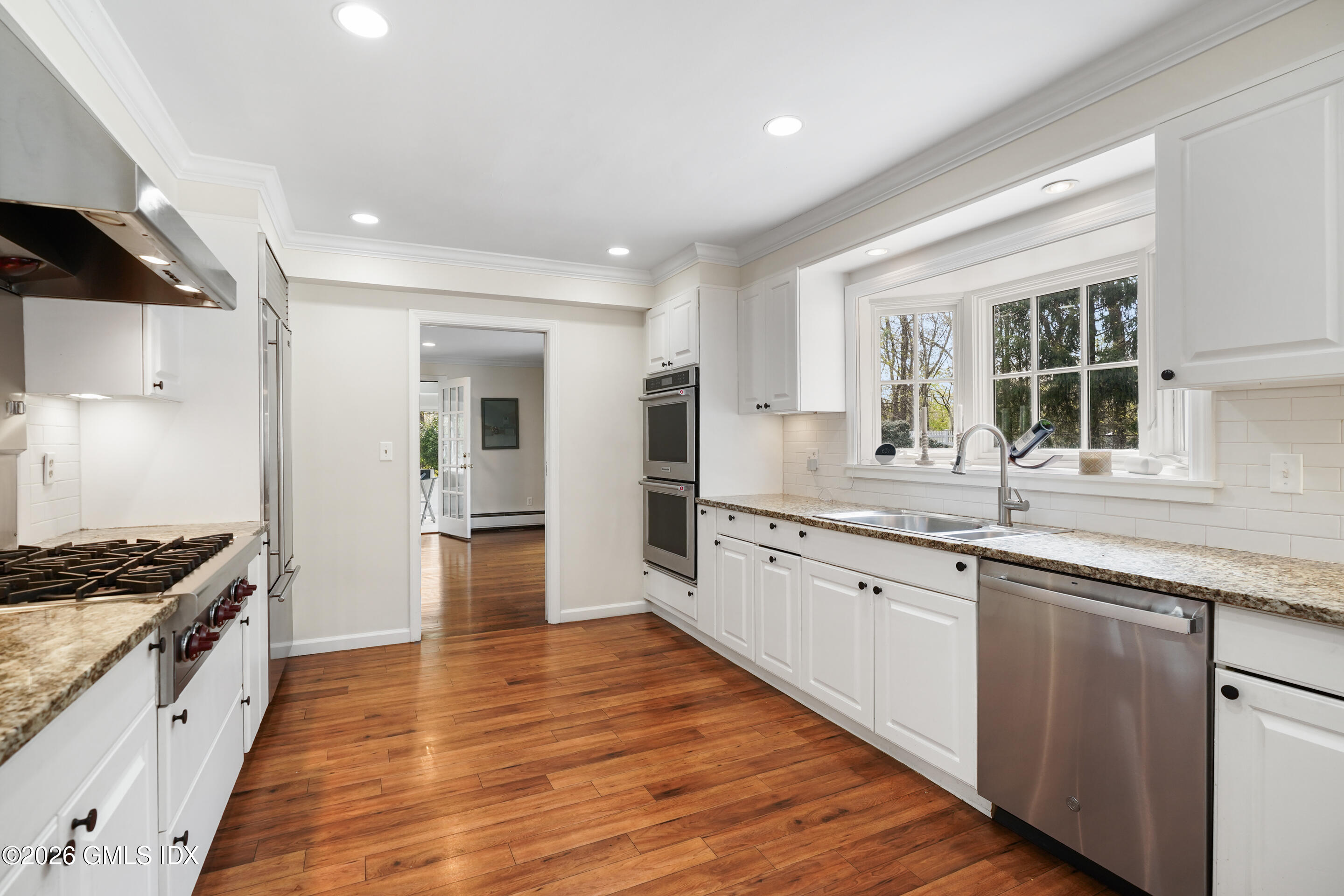 2 Daffodil Lane Cos Cob, CT 06807 - Photo 15 of 54 a large kitchen with granite countertop a large counter top space a sink stainless steel appliances and cabinets