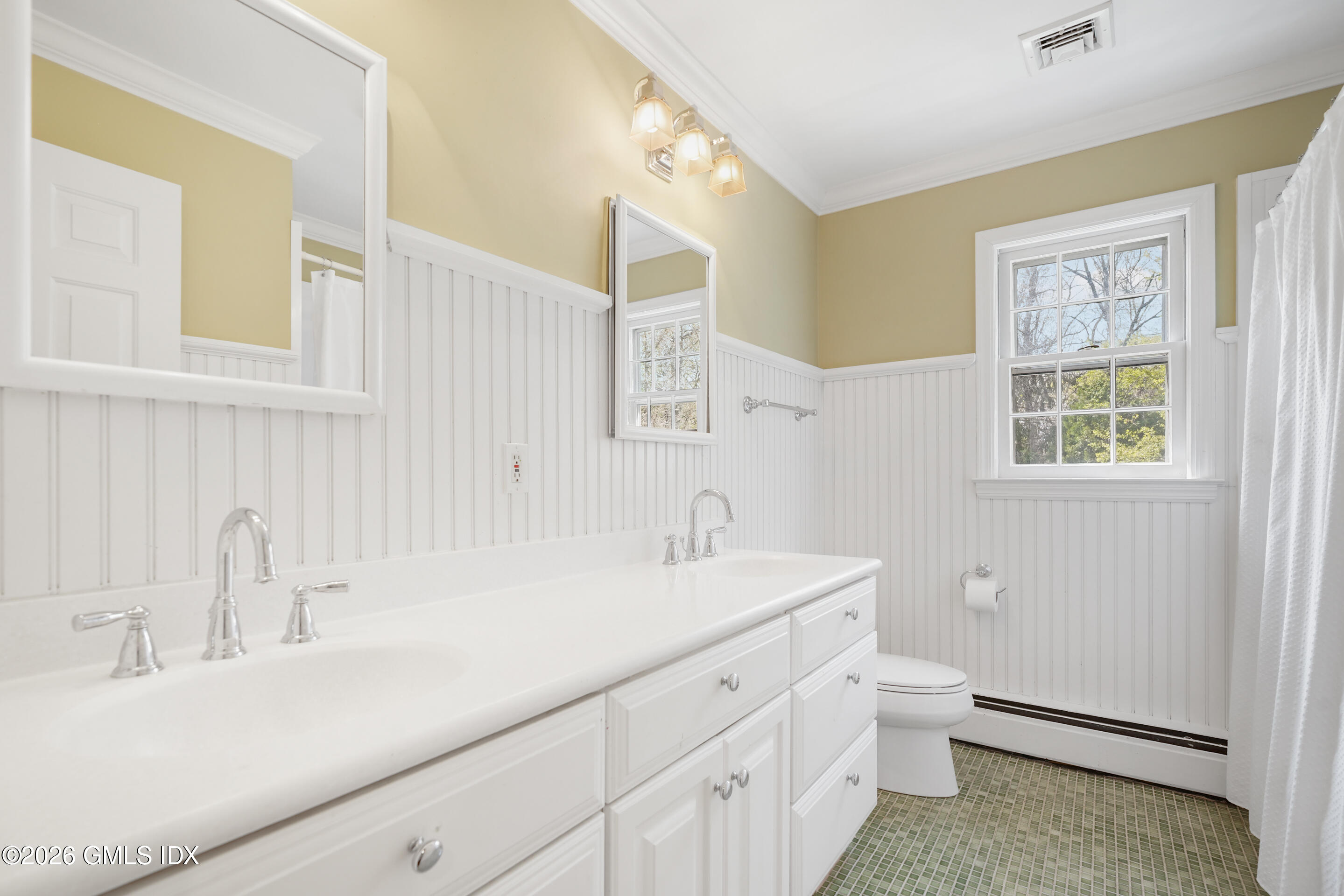 2 Daffodil Lane Cos Cob, CT 06807 - Photo 32 of 54 a bathroom with a double vanity sink a toilet and a window