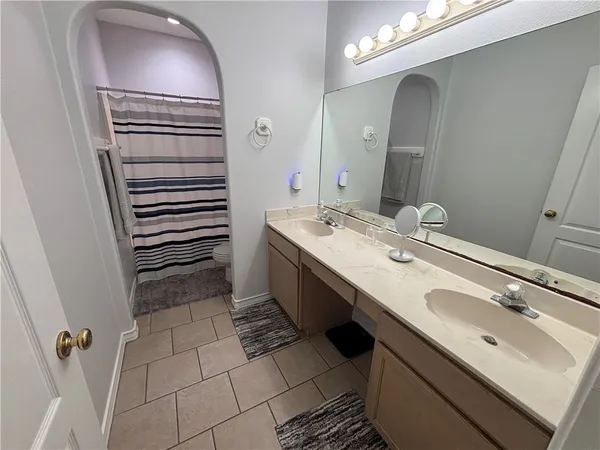 a bathroom with a sink a mirror and a shower