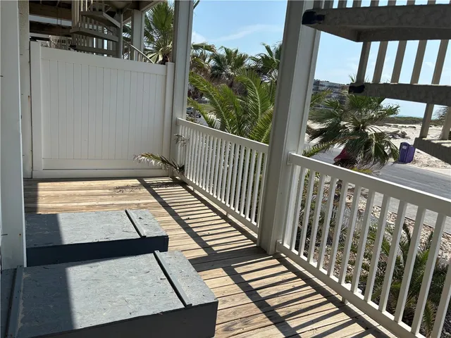 a view of a balcony with wooden floor