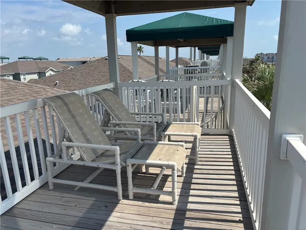 a view of a balcony with wooden floor