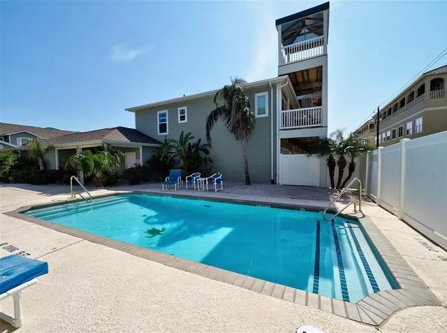 a view of swimming pool with a yard in front of it