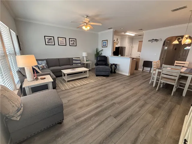 a living room with furniture and wooden floor