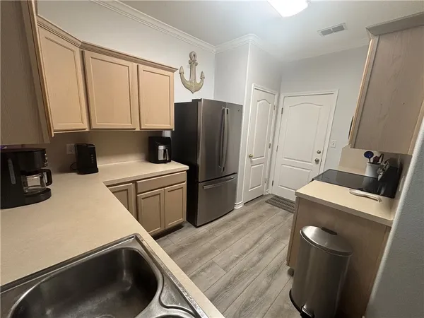 a kitchen with a refrigerator sink and stove
